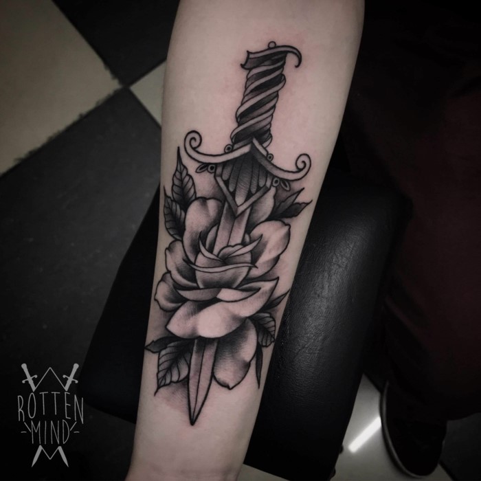 black and grey tattoo, rose pierced by a dagger, traditional tattoo designs, forearm tattoo