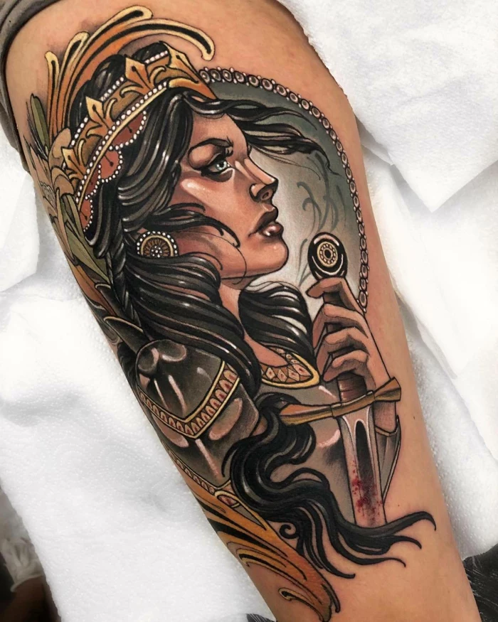 woman warrior with black hair, crown on her head, holding a sword, traditional tattoo ideas