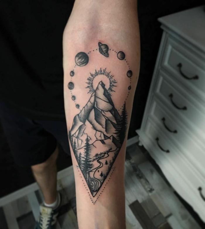 geometrical design, forearm tattoo, small mountain tattoo, mountain and trees, planets around the sun