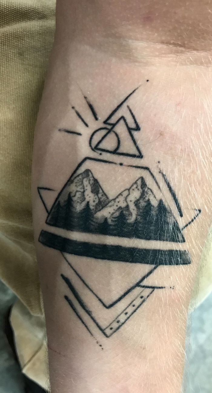 geometrical design, hiking tattoos, mountain range with trees, forearm tattoo