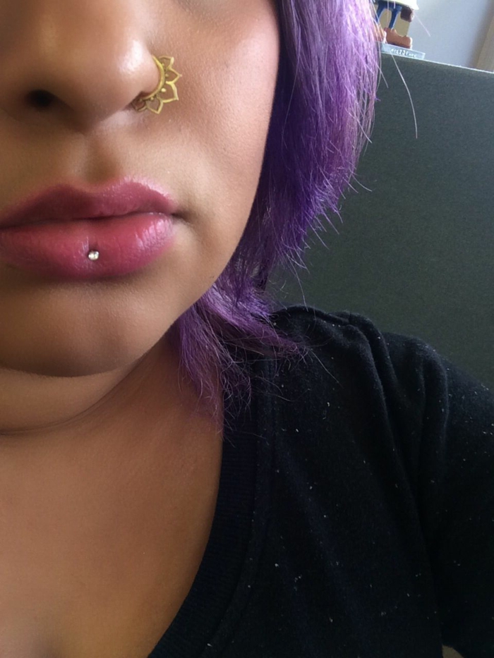 girl with purple hair, ashley lip piercing, nose ring piercing, wearing black blouse