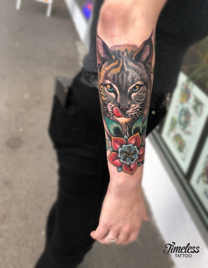 neo traditional animal tattoo, forearm tattoo, half tiger half cat face with red flower underneath