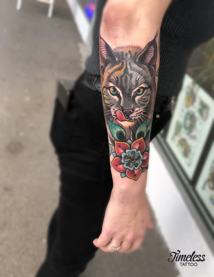 neo traditional animal tattoo, forearm tattoo, half tiger half cat face with red flower underneath