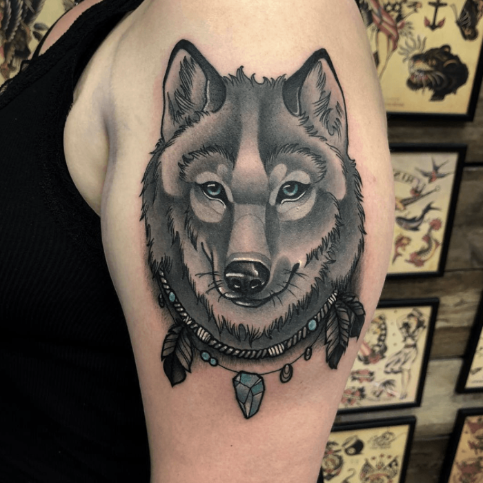 black and grey tattoo, wolf face with necklace with feathers, neo tradition...