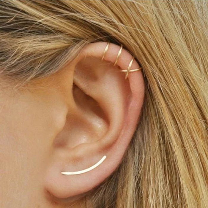 woman with blonde hair, close up photo of an ear, cartilage piercing earrings, gold ring earrings