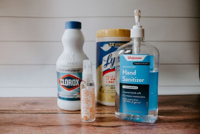 how to make hand sanitizer, hand sanitizer, plastic bottles with different ingredients, placed on wooden surface