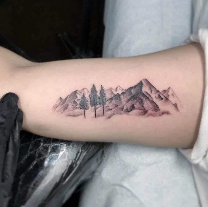 inside the arm tattoo, mountain tattoo sleeve, mountain range with trees
