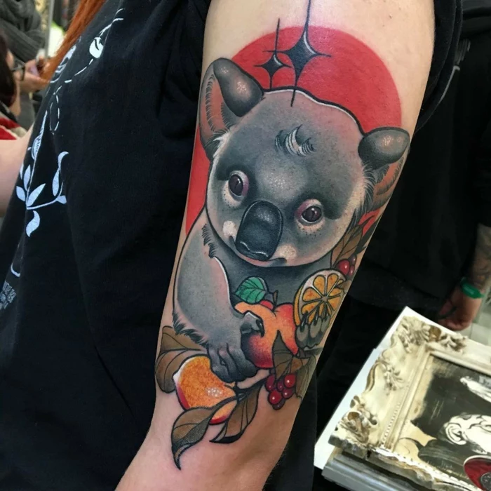 koala holding fruits, red background behind it, neo traditional rose tattoo, arm tattoo