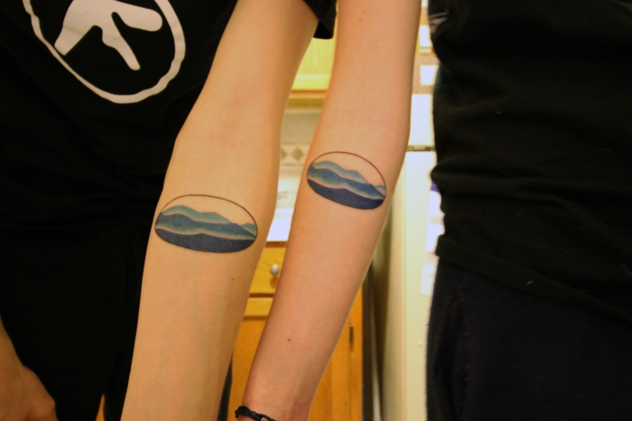 blue watercolor mountain range, drawn inside a circles, mountain tattoo sleeve, matching forearm tattoos