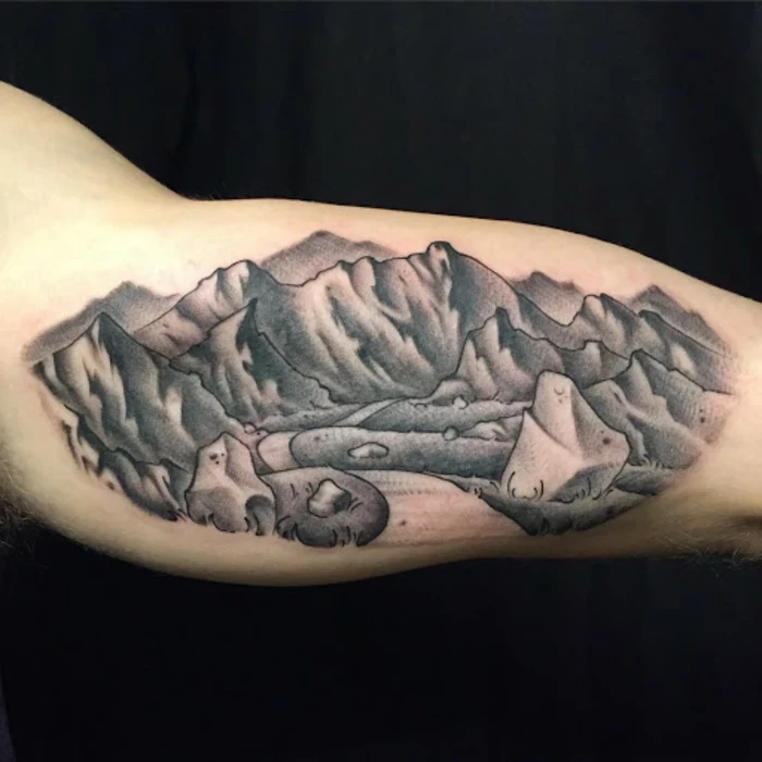 inside the arm tattoo, minimalist mountain tattoo, road between mountain peaks, black background