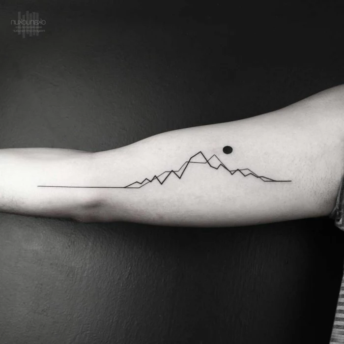 black and white photo, geometrical design, minimalist mountain tattoo, inside the arm tattoo