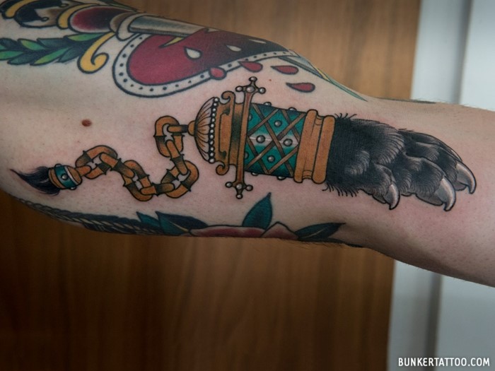 inside arm tattoo, neo traditional tattoo sleeve, animal foot on a chain, other tattoos around it