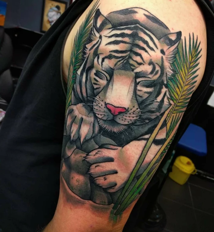 sleeping tiger, surrounded by palm leaves, traditional woman tattoo, arm tattoo