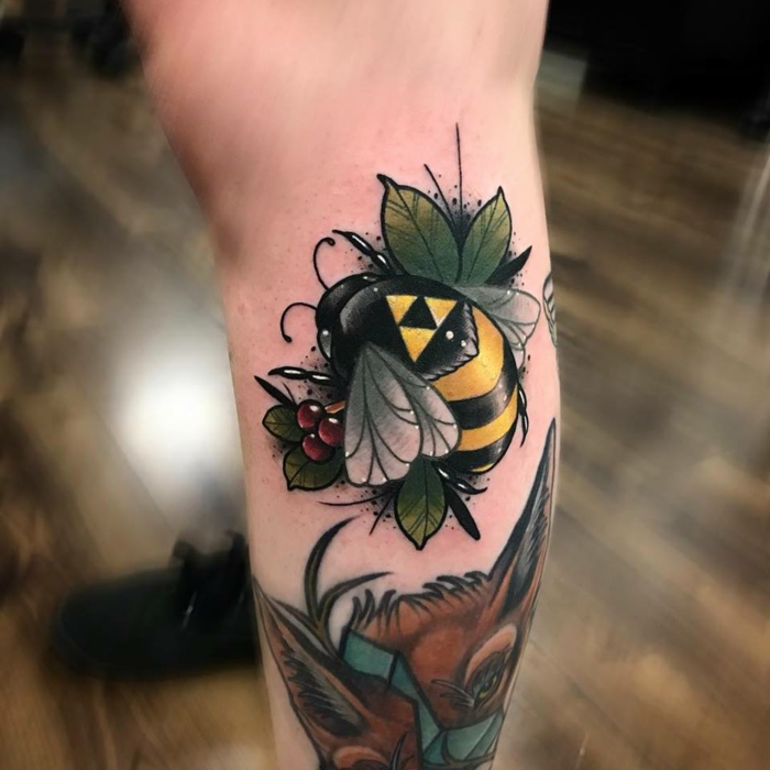 bee flying, surrounded by green leaves, traditional forearm tattoo, back of leg tattoo