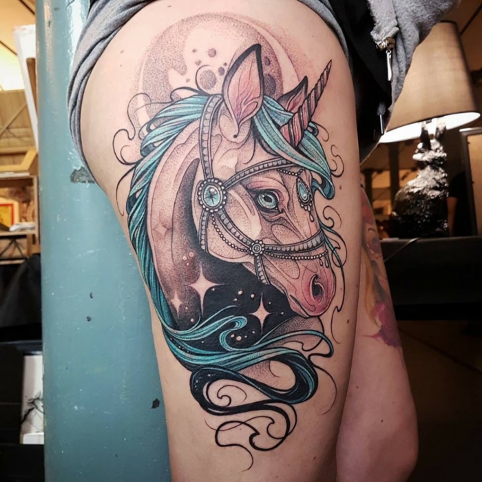 thigh tattoo, traditional forearm tattoo, unicorn with blue mane, decorated with blue rhinestones