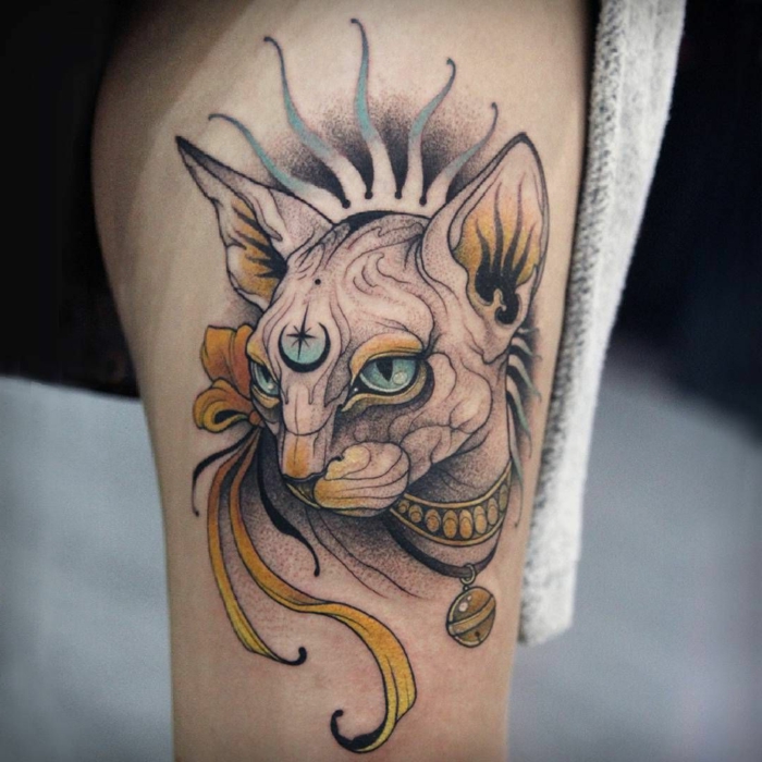 sphynx cat head with blue eyes, traditional girl tattoo, thigh tattoo