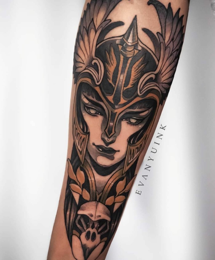 traditional style tattoos, woman warrior, female face with a large helmet with wings, forearm tattoo