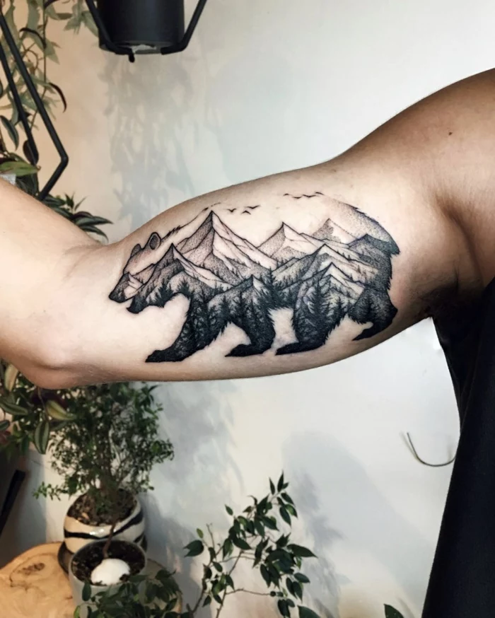 mountain range tattoo, inside the outlines of a bear, inside the arm tattoo, white background