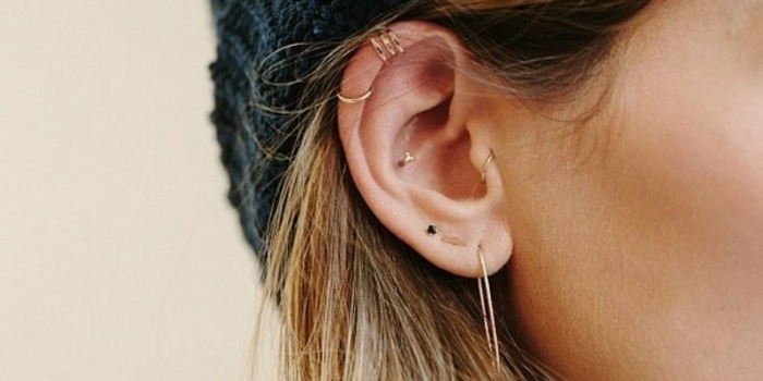 how much is a cartilage piercing, woman with blonde hair, wearing multiple different earrings