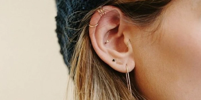how much is a cartilage piercing, woman with blonde hair, wearing multiple different earrings