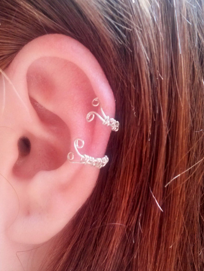 how to clean cartilage piercing, woman with brown hair, wearing two ring silver earrings