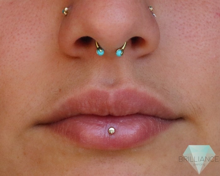 labret lip piercing, close up photo, lips with no lip gloss, seprum piercing, nose piercing