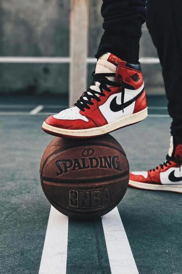 basketball wallpaper, man wearing nike air jordan ones, red black and white, stepping on a spalding ball