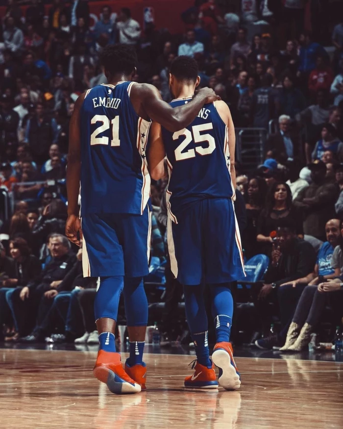 joel embiid and ben simmons, basketball backgrounds, wearing philadelphia 76ers uniforms, standing on the court