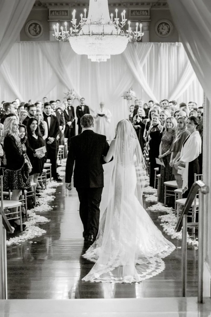 black and white photo, songs to walk down the aisle to, bride being walked down the aisle by her father