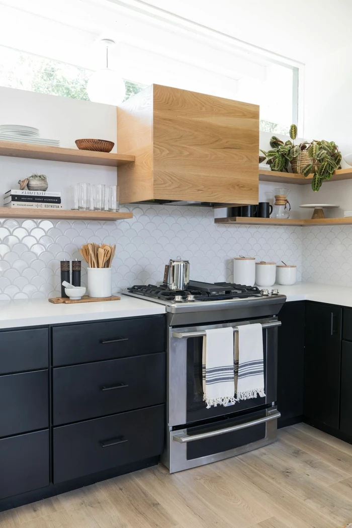black cabinets with white countertops, white tiled backsplash, mid century modern kitchen, open shelving