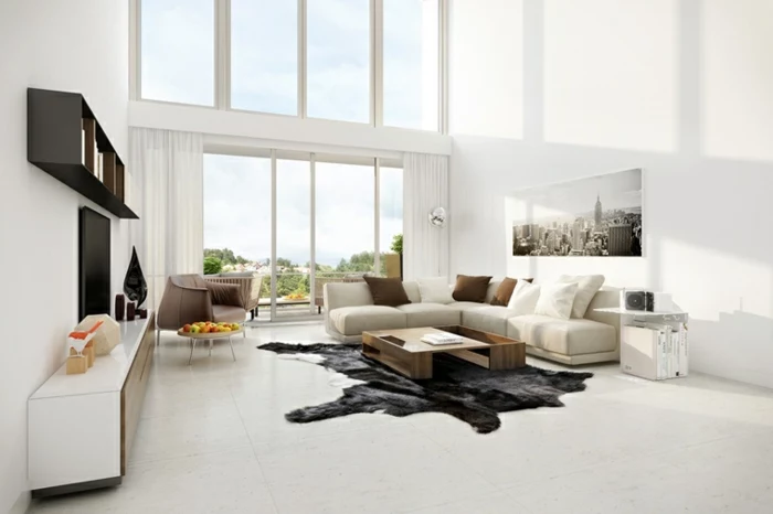 white walls, white corner sofa, white floor with black rug, how to decorate your living room
