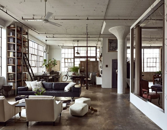 industrial apartment, black leather sofa, white armchairs, luxury living room furniture, granite floor, large bookshelf