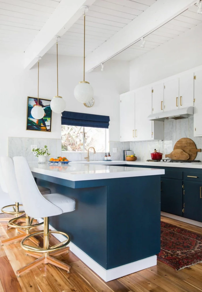 blue kitchen island and cabinets, white countertops, mid century kitchen, laminated wooden flooring