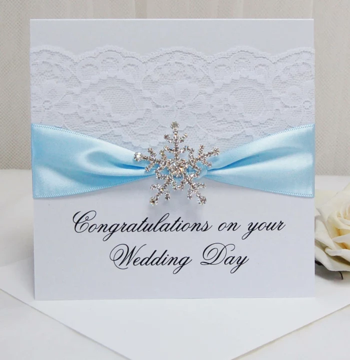 congratulations on your wedding day, written on white card stock, what to write in a wedding card, decorated with white lace and blue ribbon