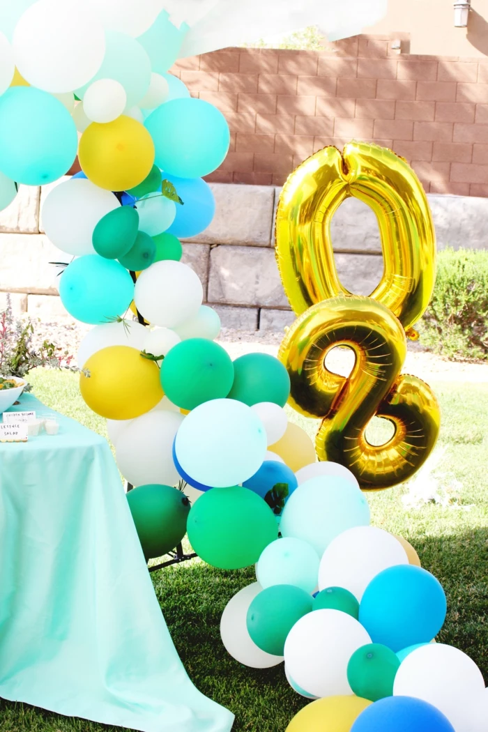 tropical theme for a party, ballon arch with blue yellow and white balloons, 80th birthday ideas for dad, number eighty balloons
