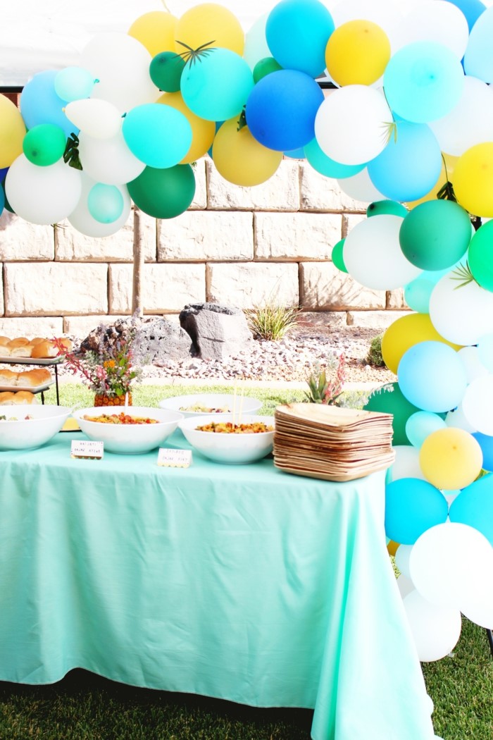 dessert table, blue white and gold balloon arch, 80th birthday ideas for dad, tropical themed party