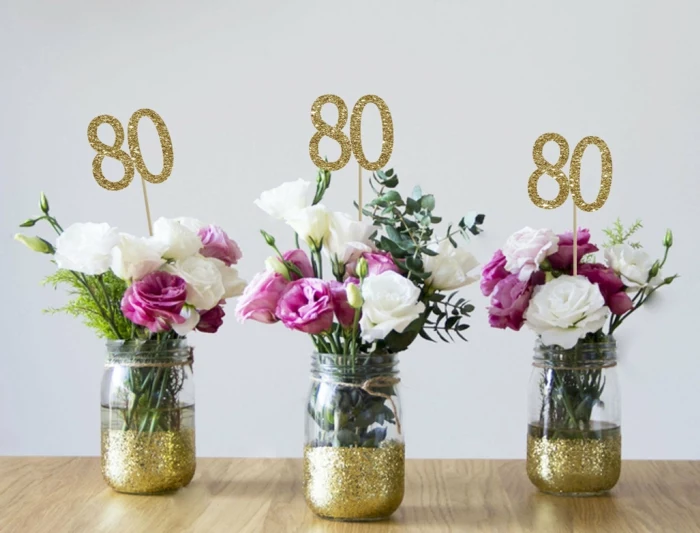 flower arrangements with white and purple roses, inside mason jars with gold glitter, 80th birthday decorations, gold glitter number 80
