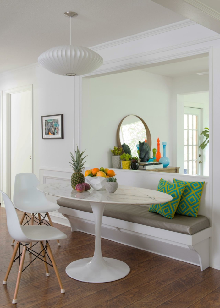 breakfast nook, bench with grey leather cushion, modern kitchen cabinets, laminated wooden flooring