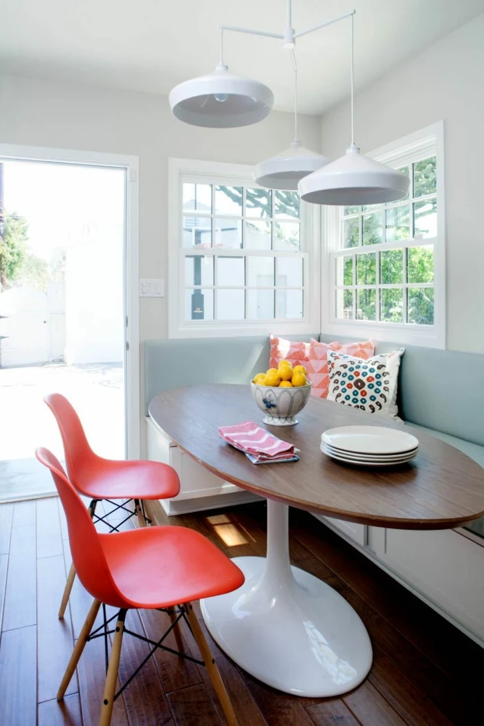 breakfast nook, mid century modern kitchen cabinets, sofa with light blue cushions, orange chairs