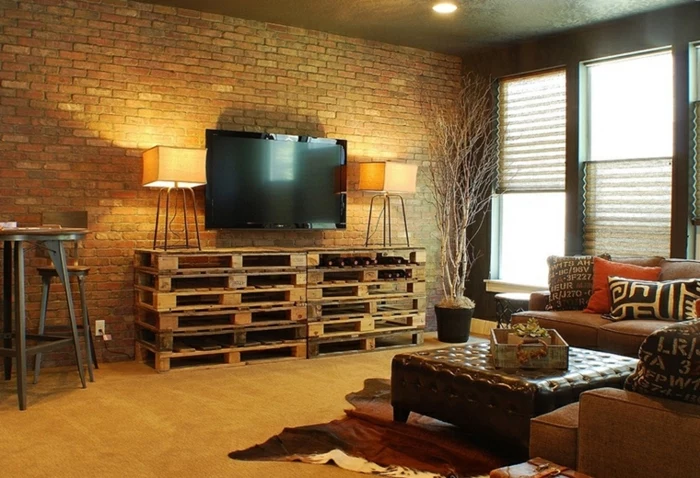 brick accent wall, pallet tv cabinet, how to decorate your living room, brown leather ottoman