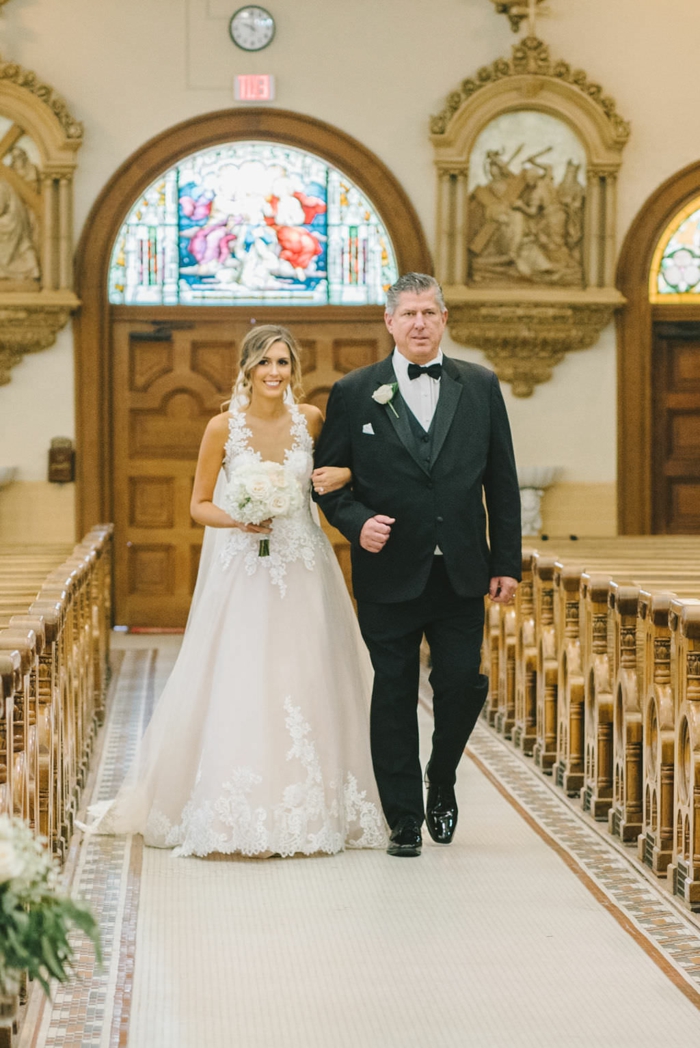 photo from inside a chapel, songs to walk down the aisle to, bride being walked down the aisle by her father