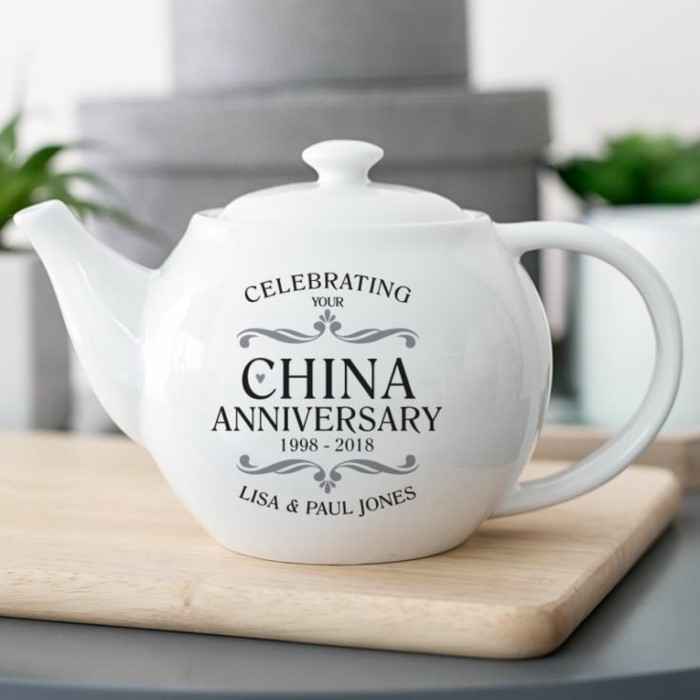 white china teapot, personalised for lisa and paul jones, 10th anniversary gift, placed on wooden surface
