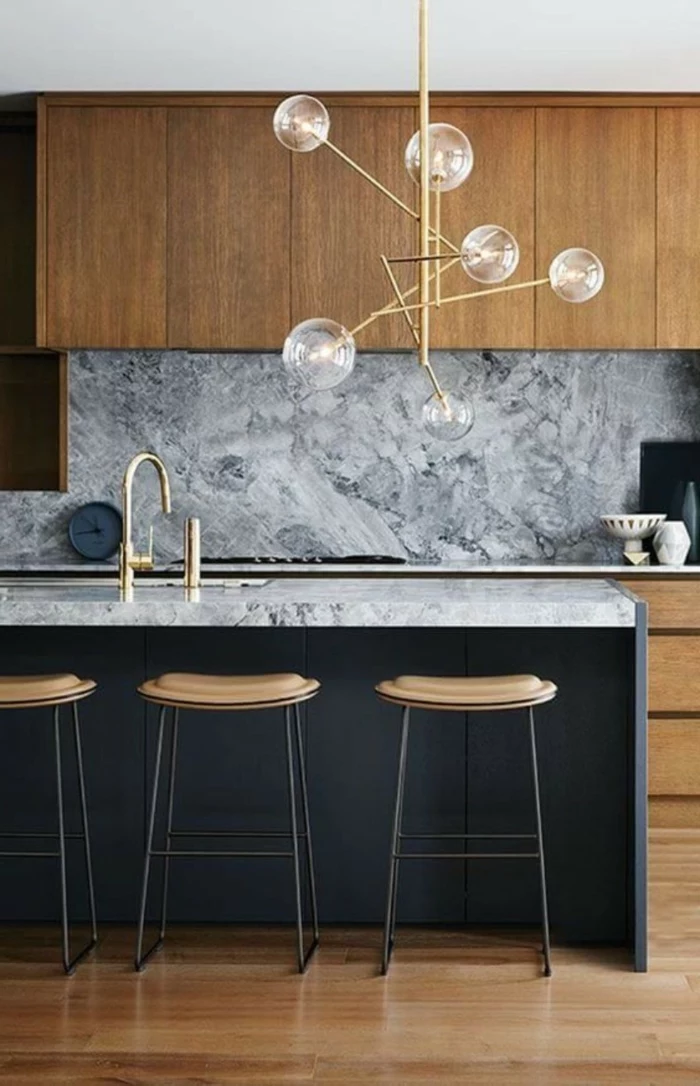 black kitchen island, wooden cabinets with marble countertops, mid century modern tile