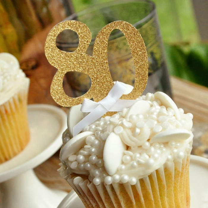 cupcake decorated with sugar pearls, 80th birthday party, gold glitter number eighty cupcake topper