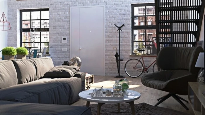 white brick wall, grey corner sofa, black armchair, modern living room decor ideas, small round coffee table