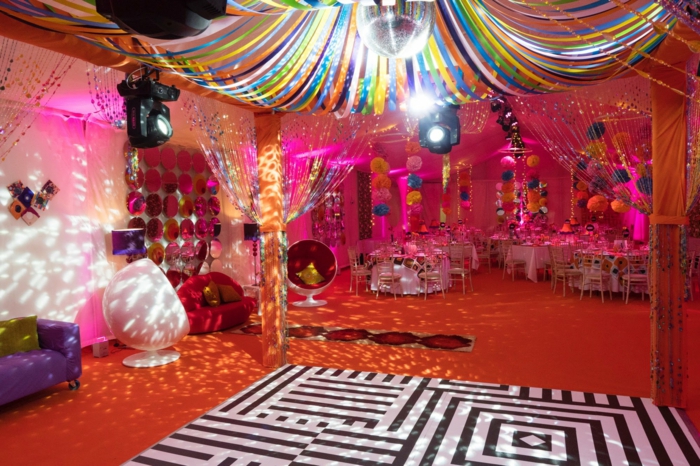 disco party with a disco ball, 18th birthday gift ideas, colorful paper flowers hanging from the ceiling