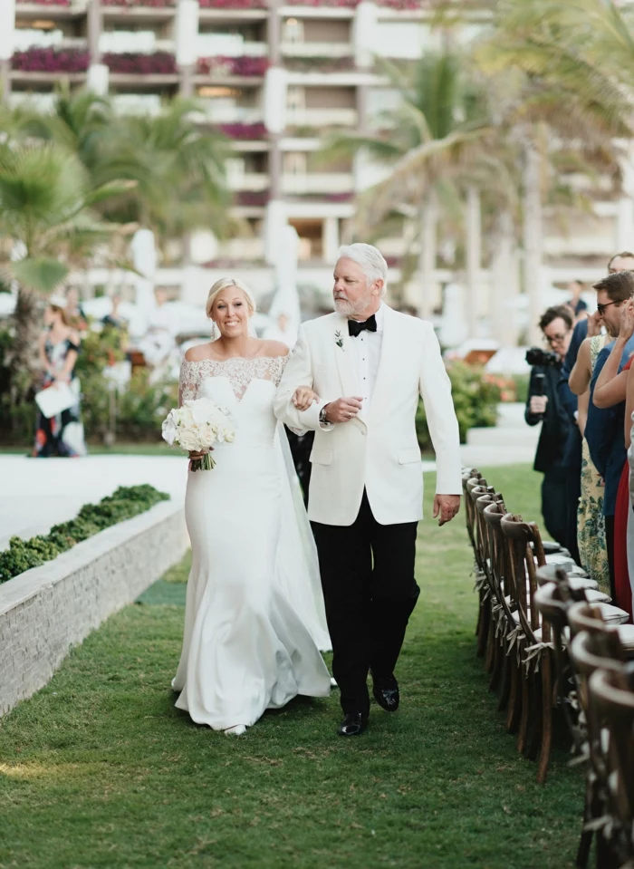bride being walked down the aisle by her father, wedding ceremony songs, garden wedding, palm trees in the background