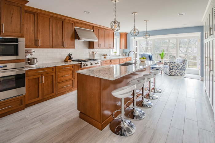 wooden cabinets with granite countertops, mid century modern tile, laminated wooden flooring