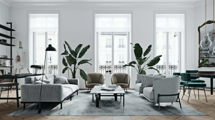 white walls with tall windows, modern living room furniture, grey sofa and armchairs, small coffee table