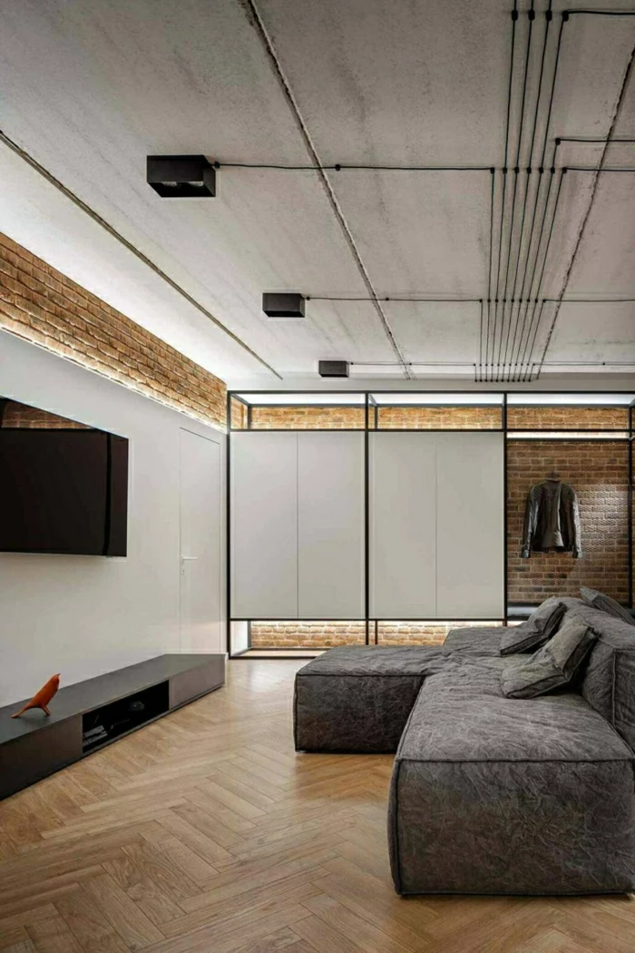 brick walls, grey corner sofa, modern living room sets, wooden floor, small tv cabinet